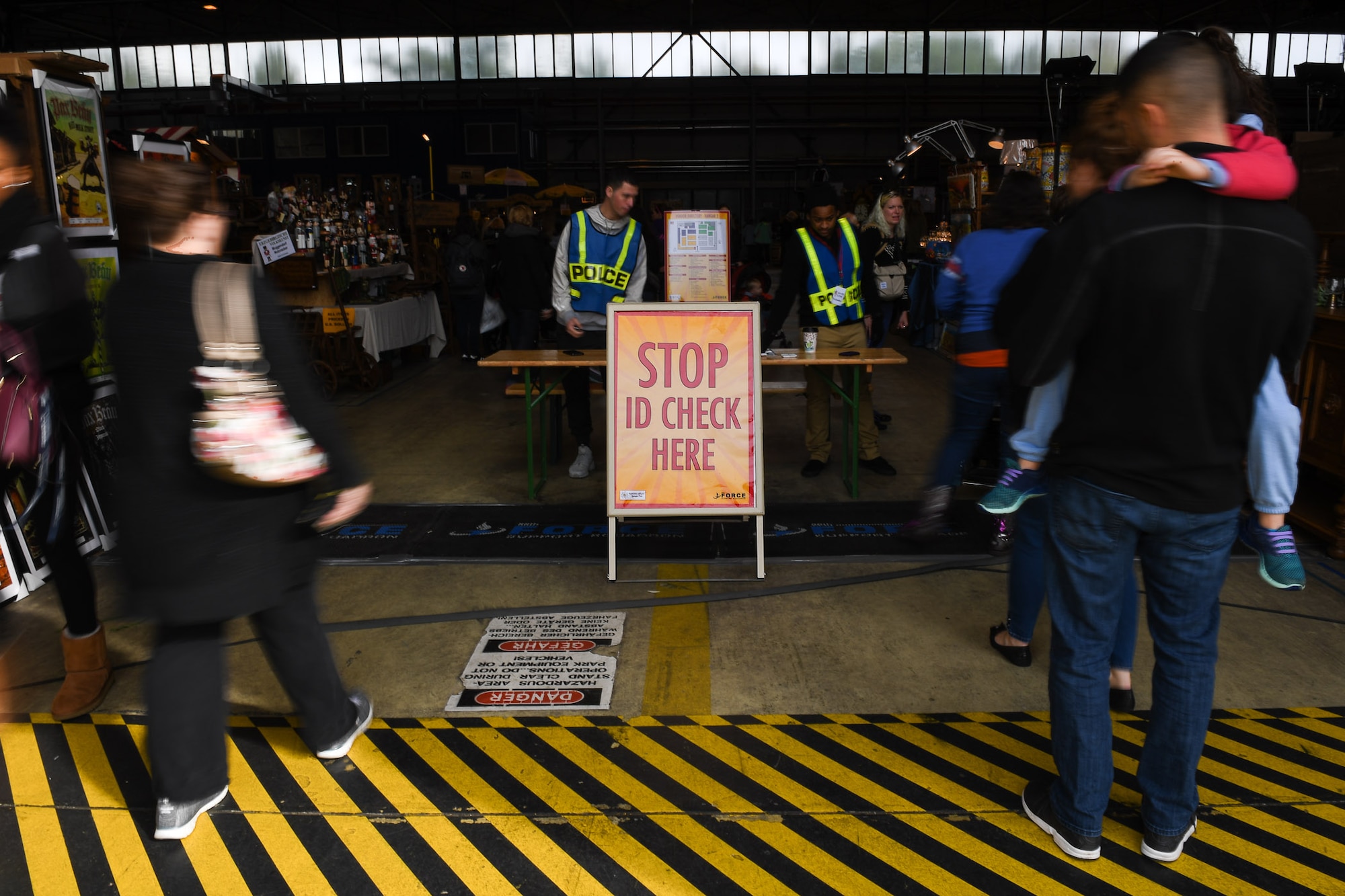 Volunteers for the 2017 Ramstein Bazaar, check identification cards on Ramstein Air Base, Germany, Sept 15, 2017.
