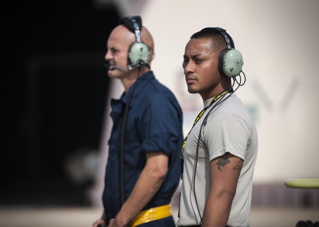 U.S. Air Force Staff Sgt. Eugene Travis, 8th Air Maintenance Squadron crew chief, and Airman 1st Class Anthony Martinez, 8th Security Forces Squadron defender, prepare to launch a jet while participating in the “Job Swap” event at Kunsan Air Base, Republic of Korea, Sept. 12, 2017. The event aimed to give a hands-on look at the mission that 8th SFS defenders are supporting and protecting. (U.S. Air Force photo by Staff Sgt. Victoria H. Taylor)