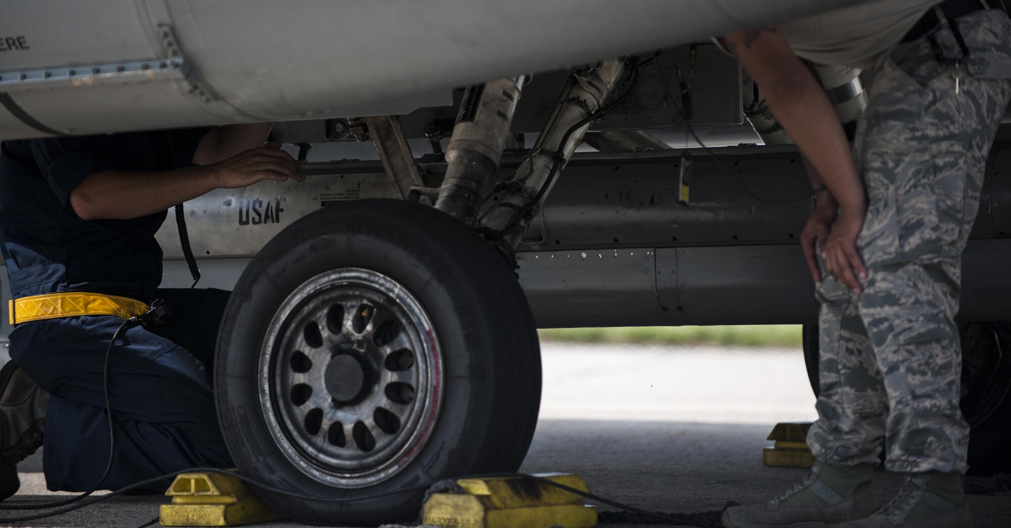 U.S. Air Force Staff Sgt. Eugene Travis, 8th Air Maintenance Squadron crew chief, briefs Airman 1st Class Anthony Martinez, 8th Security Forces Squadron defender, while participating in the “Job Swap” event at Kunsan Air Base, Republic of Korea, Sept. 12, 2017. Travis taught Martinez the basic functions of the aircraft so that he can better understand the assets that he and other 8th SFS defenders are protecting day in and day out. (U.S. Air Force photo by Staff Sgt. Victoria H. Taylor)