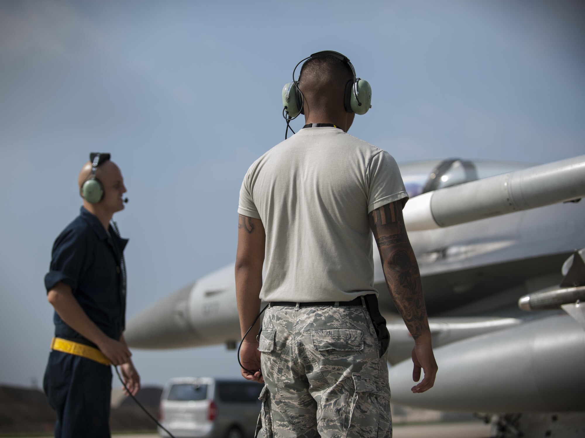 U.S. Air Force Staff Sgt. Eugene Travis, 8th Air Maintenance Squadron crew chief, and Airman 1st Class Anthony Martinez, 8th Security Forces Squadron defender, prepare to launch a jet while participating in the “Job Swap” event at Kunsan Air Base, Republic of Korea, Sept. 12, 2017. Travis taught Martinez the basic functions of the aircraft so that he can better understand the assets that he and other 8th SFS defenders are protecting day in and day out. (U.S. Air Force photo by Staff Sgt. Victoria H. Taylor)