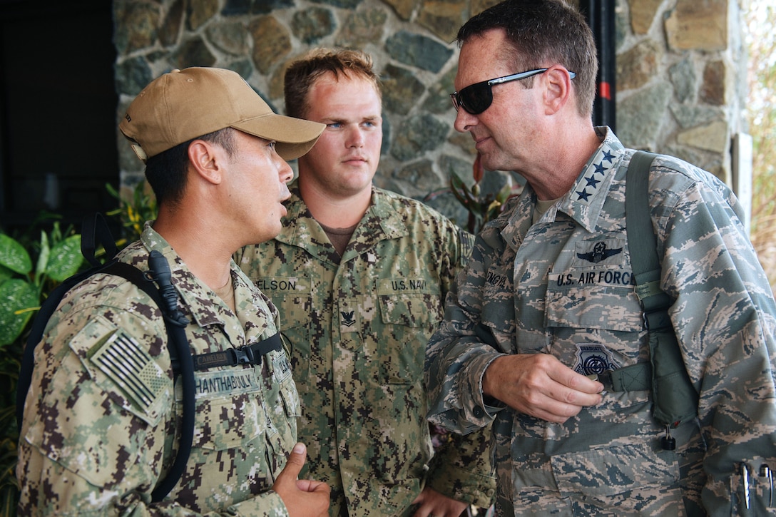 Gen. Joseph L. Lengyel, the chief of the National Guard Bureau, speaks with Navy Chief Boupha Chanthabouly, left, and Navy Petty Officer 2nd Class Michael Nelson