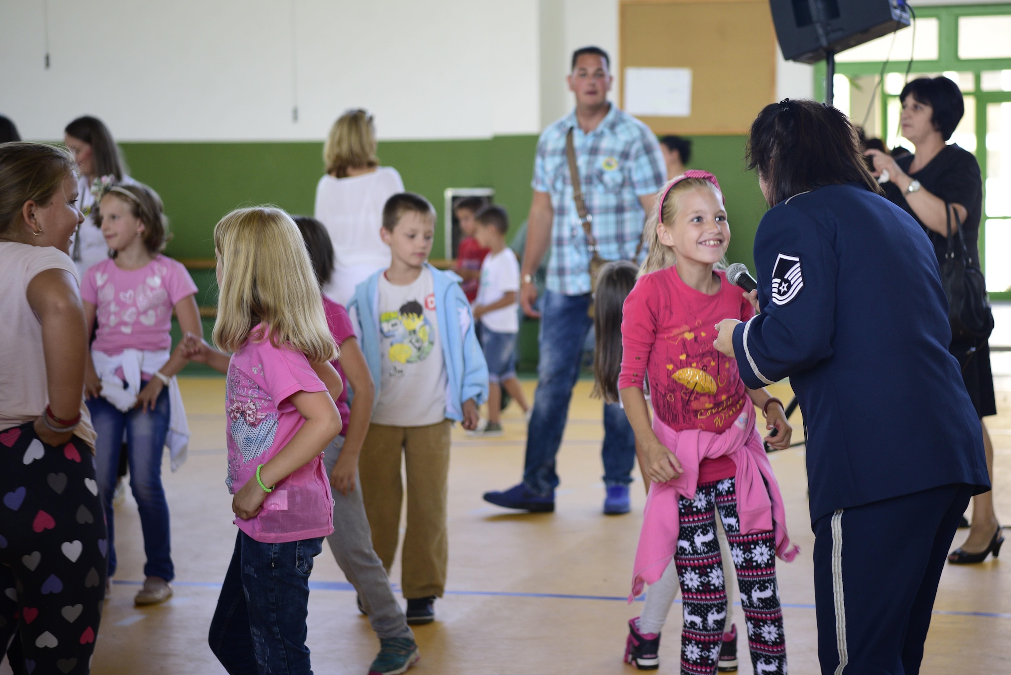 U.S. Air Force Master Sgt. Michele Harris, U.S. Air Forces in Europe band vocalist, sings with local children in Pranjani, Serbia, Sept. 16, 2017.