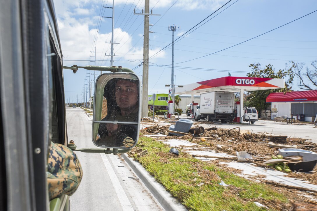 Lance Cpl. Trenton Laake, a heavy equipment mechanic with Marine Wing Support Squadron 473, 4th Marine Aircraft Wing, Marine Forces Reserve, looks out of a Humvee as it drives through the streets of Marathon, Fla.
