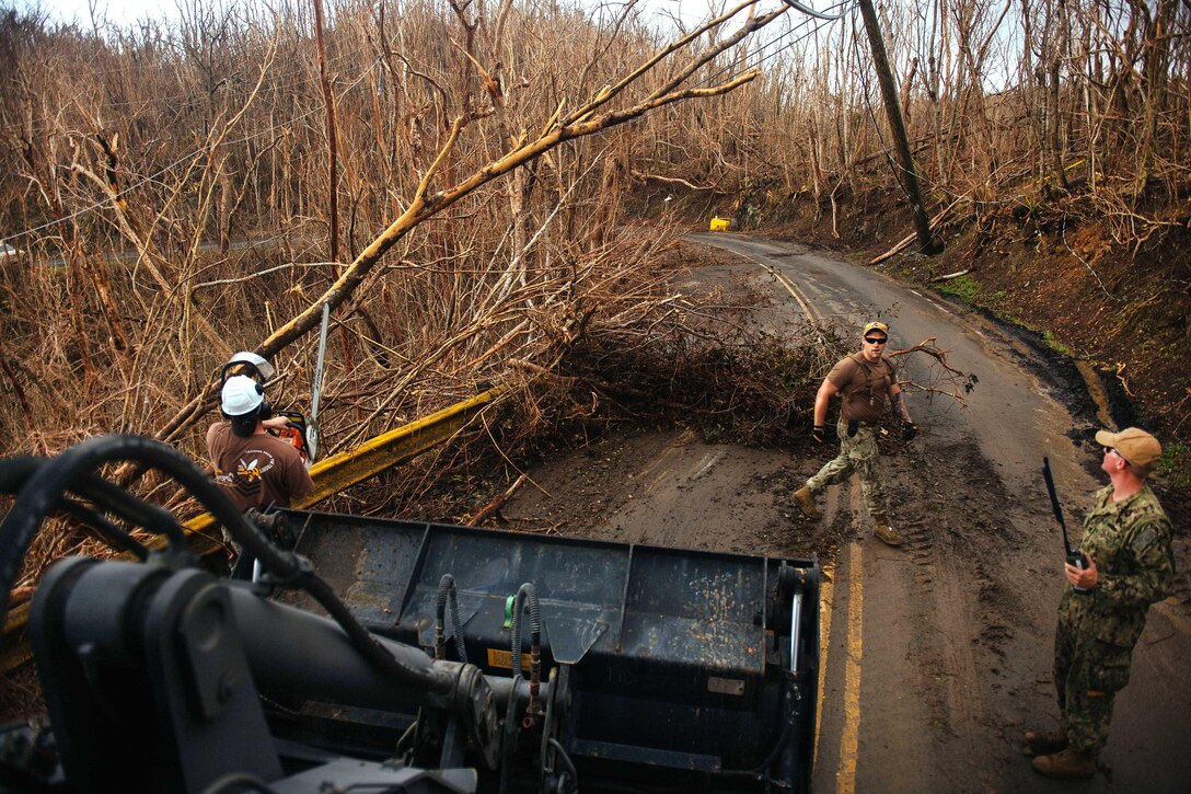 A Seabee operates a bulldozer clearing debris from a roadway during clearing operation on St. John.