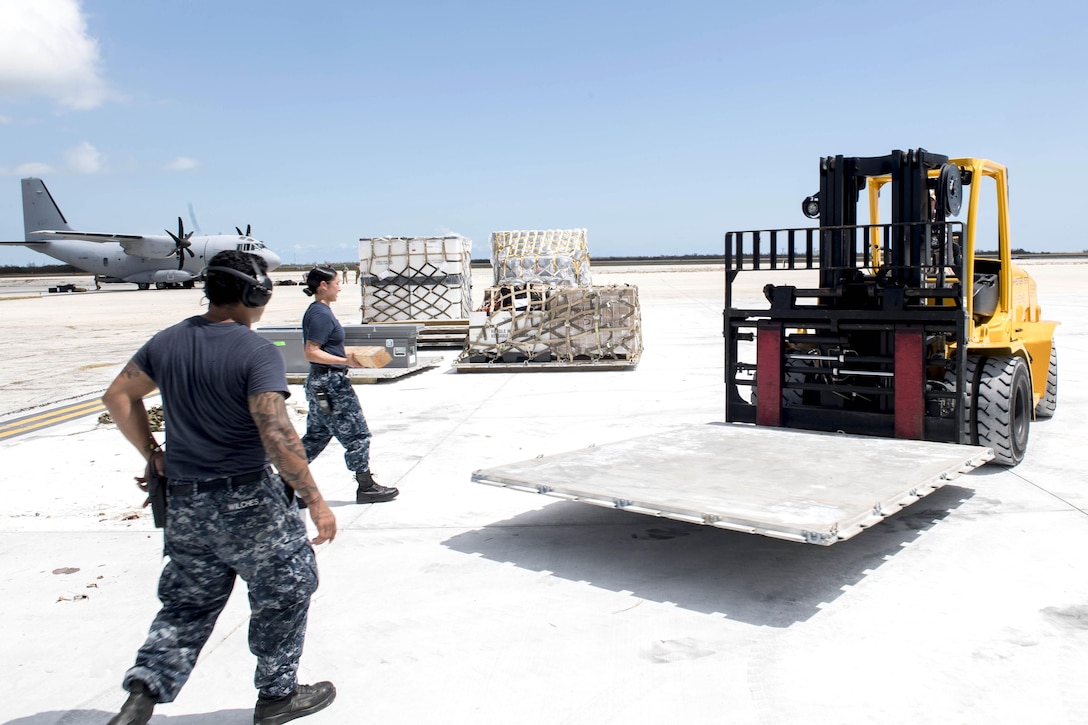 Sailors move pallets of supplies on the airstrip at Naval Air Station Key West.
