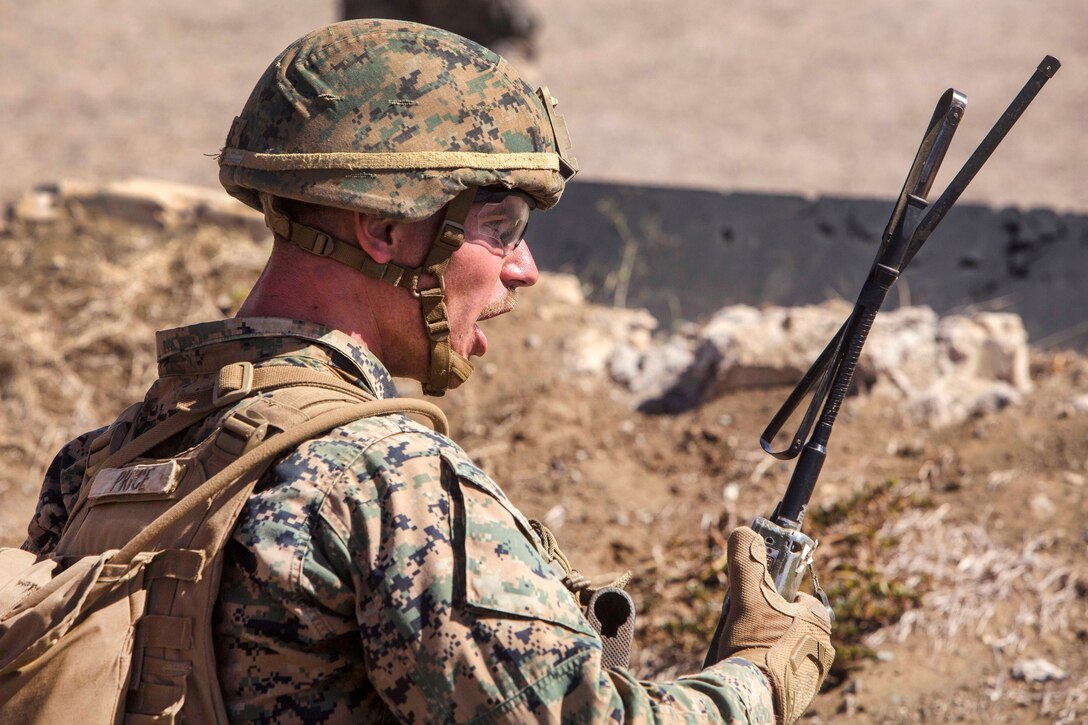 A Marine yells out orders to his team during an advanced infantry course.