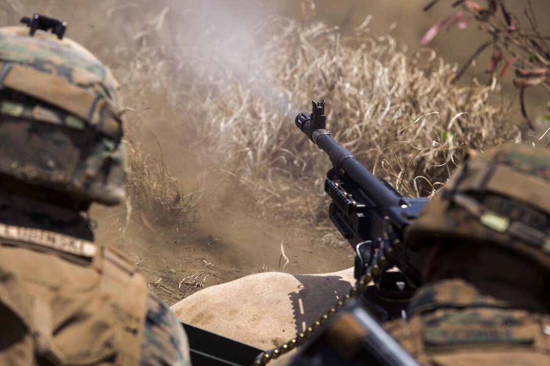 A Marine fires a M240B machine gun at targets during an advanced infantry course.