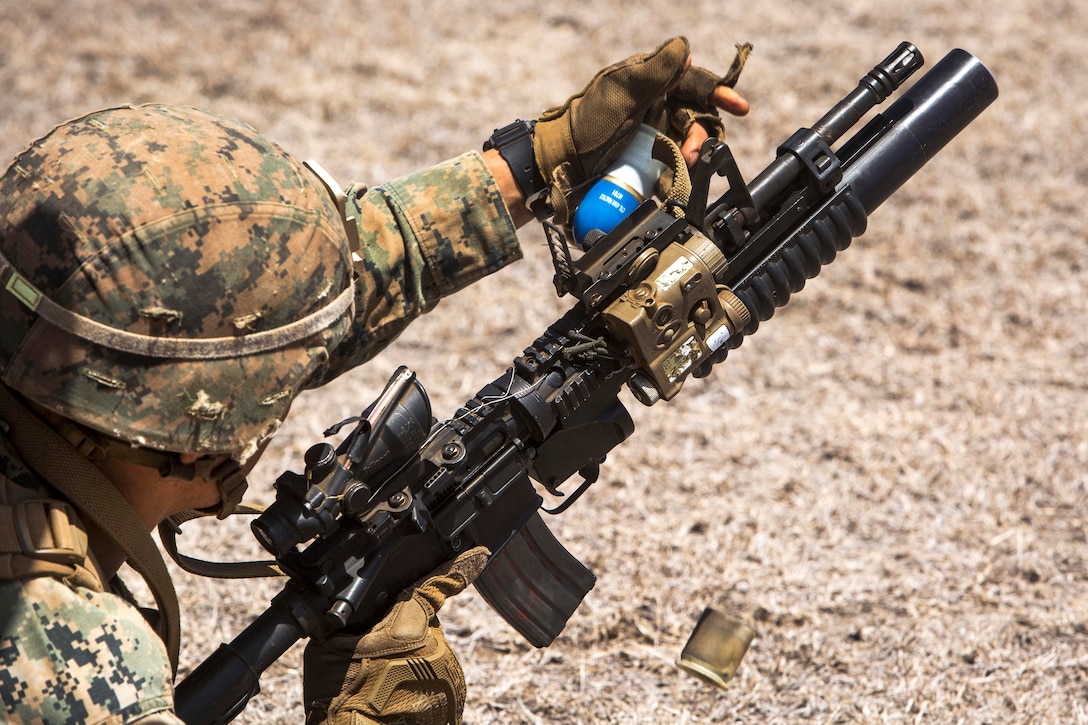 A Marine prepares to load an M203 grenade launcher during an advanced infantry course.