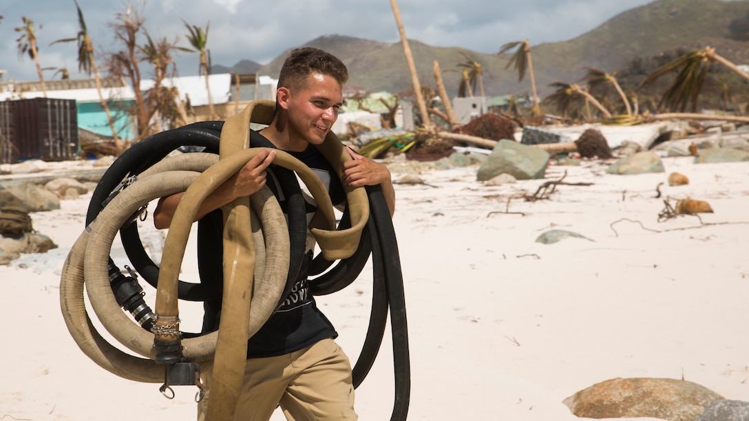 U.S. Marine Lance Cpl. Dakota Medina, a landing support specialist with Joint Task Force - Leeward Islands, carries hoses belonging to a Lightweight Water Purification System from a box truck at Orient Beach, Saint Martin, Sept. 16, 2017. The Marines arrived to assess possible locations to set up their LWPS in order to produce potable water for communities on the island most affected by Hurricane Irma. At the request of partner nations, JTF-LI deployed aircraft and service members to areas in the eastern Caribbean Sea impacted by the storm. The task force is a U.S. military unit composed of Marines, Soldiers, Sailors, and Airmen, and represents U.S. Southern Command’s primary response to Hurricane Irma.