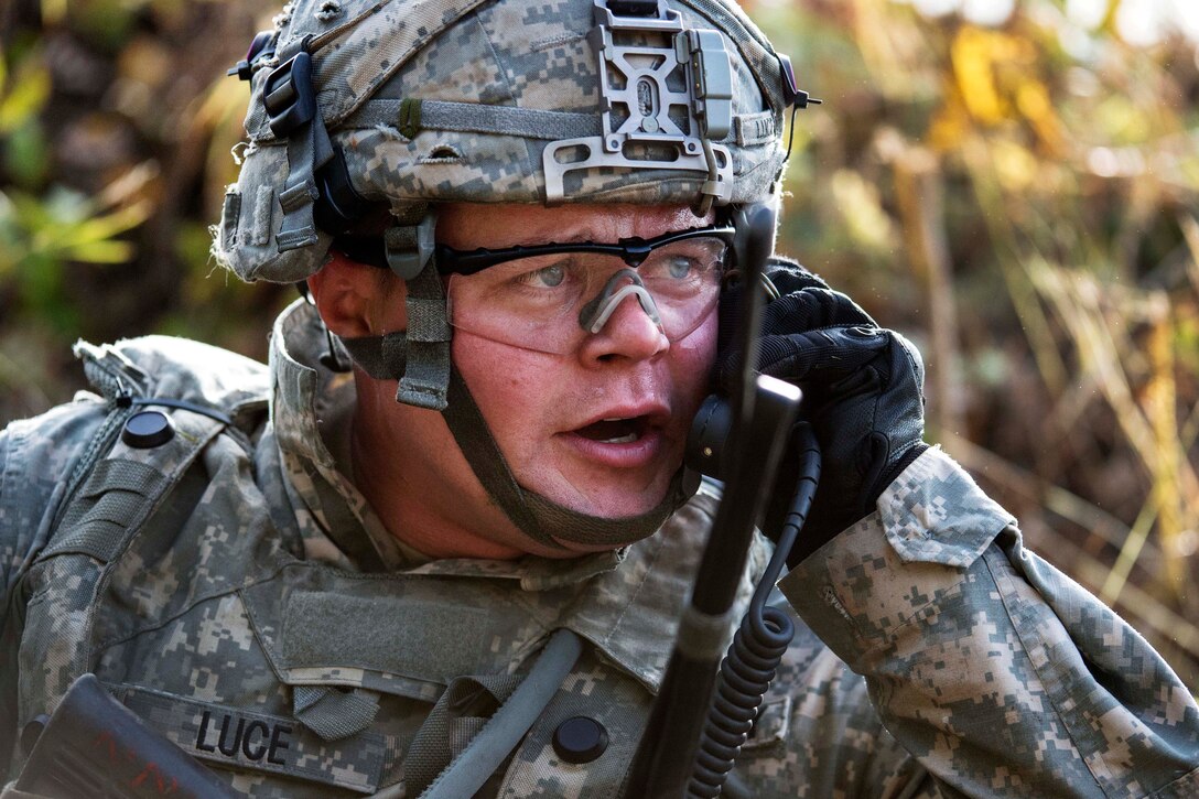 Army Sgt. James Luce relays his position to his headquarters during live-fire training.