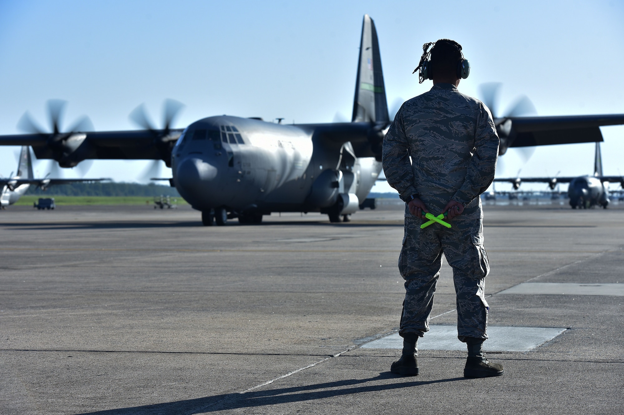 Airman 1st Class Omar Campos, 19th Airlift Maintenance Squadron crew chief, readies himself to marshal a C-130J taking members of Team Little Rock on the first leg of their trip to a deployment, at Little Rock Air Force Base, Ark. (U.S. Air Force photo by Airman Rhett Isbell)