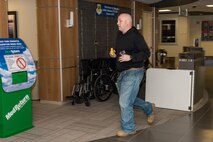 Tech. Sgt. Rouven Sefcik, 436th Medical Operations Squadron mental health flight chief, runs in the Medical Clinic lobby looking for potential victims during an active shooter exercise Sept. 12, 2017, at Dover Air Force Base, Del. Sefcik and Tech. Sgt Jason Walls, 436th MDOS family health flight chief, played the roles of active shooters who mortally wounded 436th Medical Group personnel and first responders, as well as taking numerous hostages during the exercise. (U.S. Air Force photo by Roland Balik)