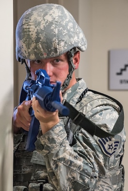 Staff Sgt. Jesse Johnson, 436th Security Forces Squadron response force leader, stands guard in the Mental Health clinic lobby during an active shooter exercise Sept. 12, 2017, at the Base Clinic, Dover Air Force Base, Del. Johnson made phone contact with the exercise active shooter who barricaded himself in the clinic, along with an undetermined number of hostages, wounded individuals, or casualties. (U.S. Air Force photo by Roland Balik)