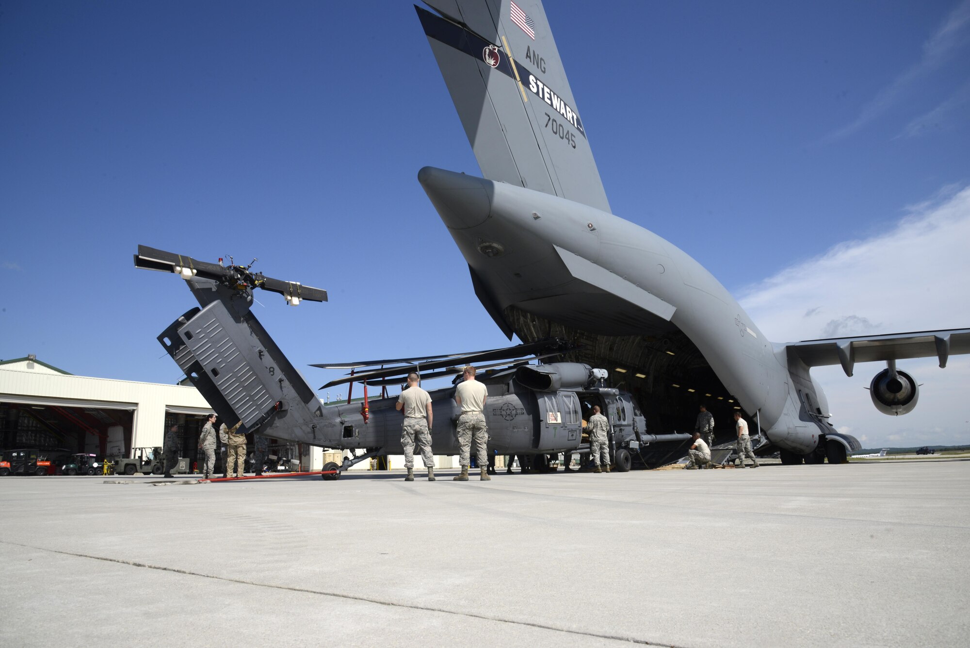 Airmen assigned to the 105th Airlift Wing and 106th Rescue Wing load two HH-60 Pavehawk helicopters onto a C-17 Globemaster III at Gabreski Air National Guard Base, West Hampton Beach, New York Sept. 7, 2017.
