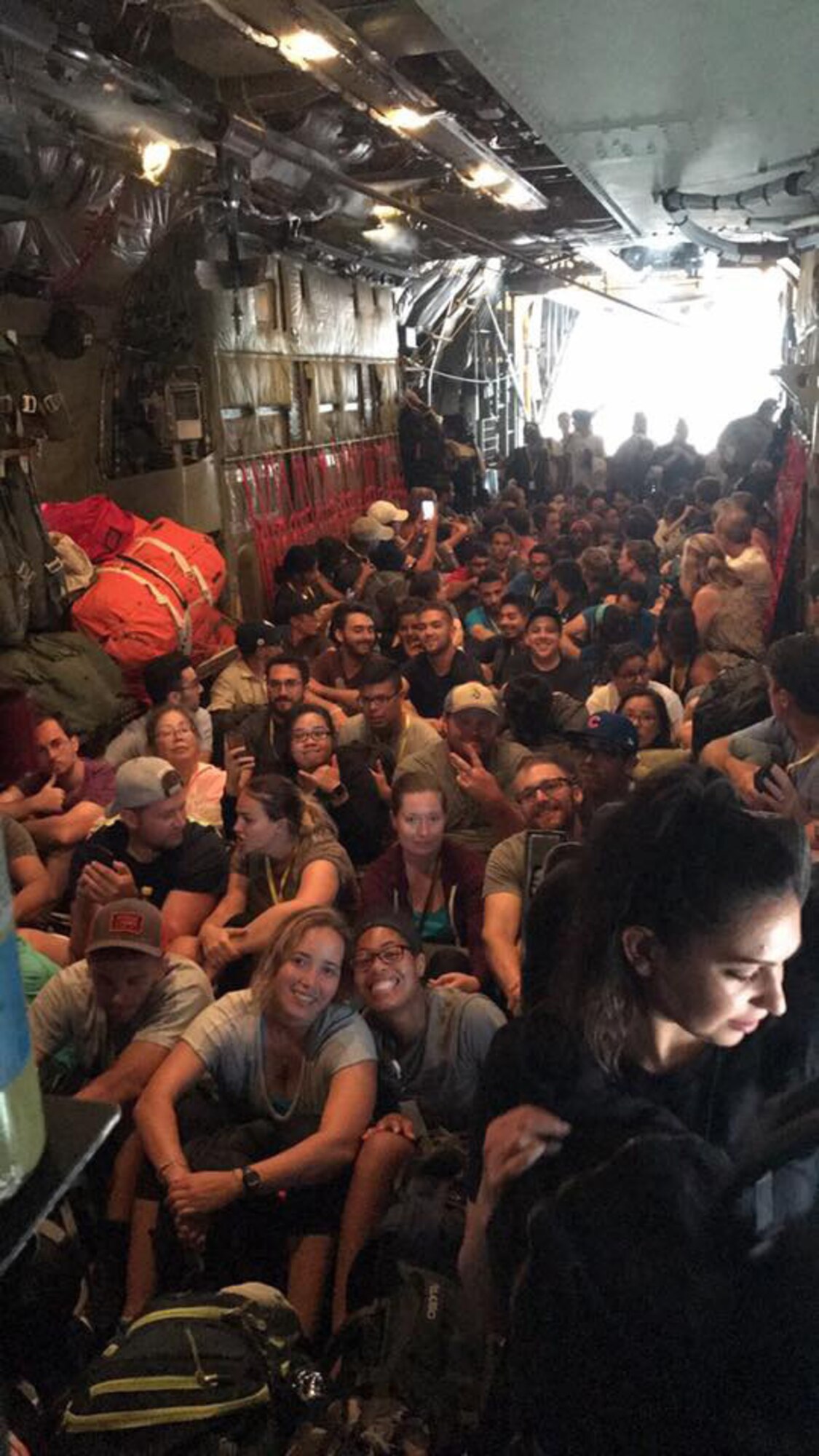 Evacuees prepare for their departure on board a New York Air National Guard HC-130 assigned to the 106th Rescue Wing from Princess Juliana International Airport in St. Maarten, September 8, 2017.