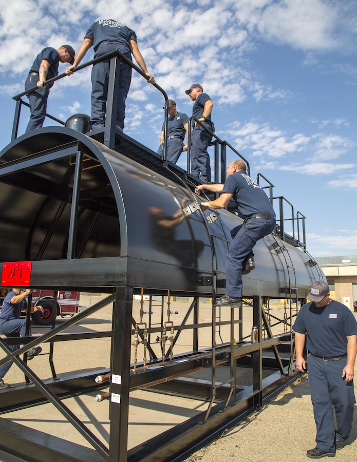 Firefighters with Fire and Emergency Services climb aboard their new three-domed railcar training simulator, created by Advanced Entertainment Technologies, during a training exercise aboard Marine Corps Logistics Base Barstow, Calif., Aug. 30. The simulator offers several realistic training situations to help ensure that firefighters are prepared for potential railway emergencies on base or within the local area.