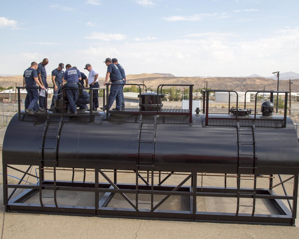 Firefighters with Fire and Emergency Services train on their new three-domed railcar training simulator created by Advanced Entertainment Technologies, during a training exercise aboard Marine Corps Logistics Base Barstow, Calif., Aug. 30. The railcar simulator offers several realistic training situations to help ensure that firefighters are prepared for potential railway emergencies on base or within the local area.