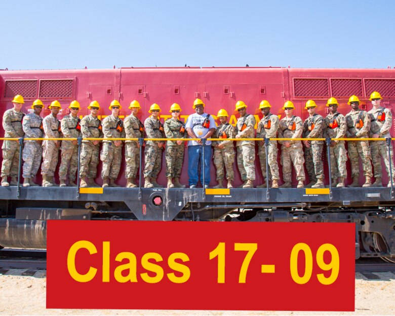 Students enrolled in the Railway Operations Group Training Course take a class portrait during their training at the Yermo Annex aboard Marine Corps Logistics Base Barstow, Calif., Aug. 31. During the training, students learn to safely load, span, secure and unload equipment on railcars for safe transportation to and from military bases all over the country. The base is home to the largest railhead in the Department of Defense and is the only source for intermediate and advanced railway operations training.