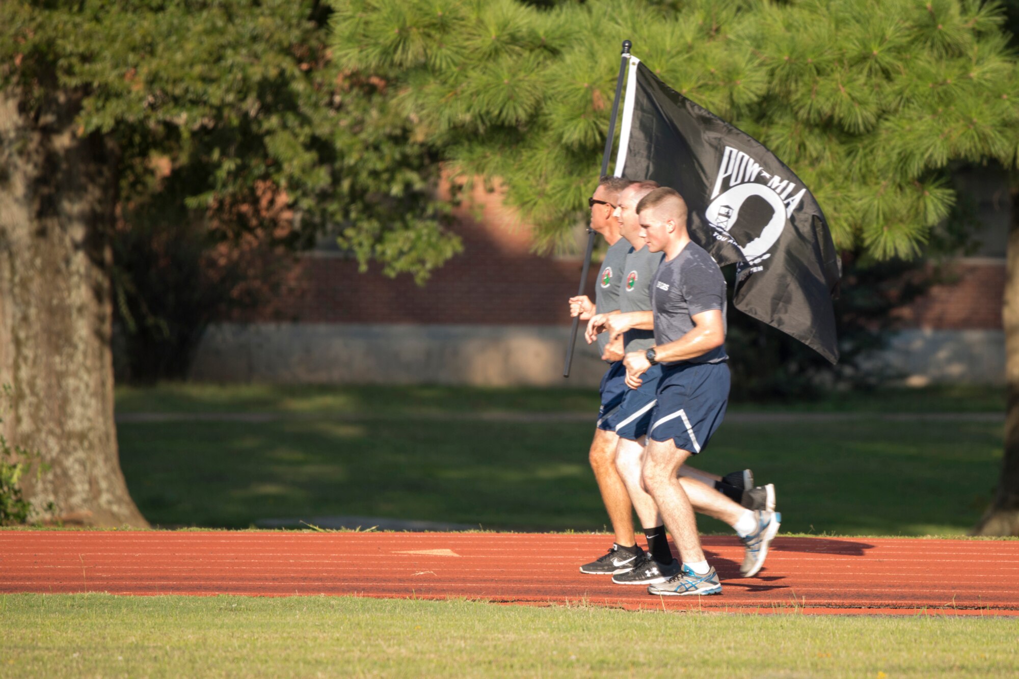 Airmen from 913th Airlift Group and 19th Logistics Readiness Squadron observe National POW and MIA Recognition Day at Little Rock Air Force Base, Ark., Sept. 14, 2017, by participating in a 24-hour vigil honoring prisoners of war and those who are still missing in action. Runners from all the units on base volunteered to runs laps in 1-hour time slots with the POW/MIA flag to keep it moving for 24 hours in observance of National POW and MIA Recognition Day. (U.S. Air Force photo by Capt. Casey Staheli/Released)