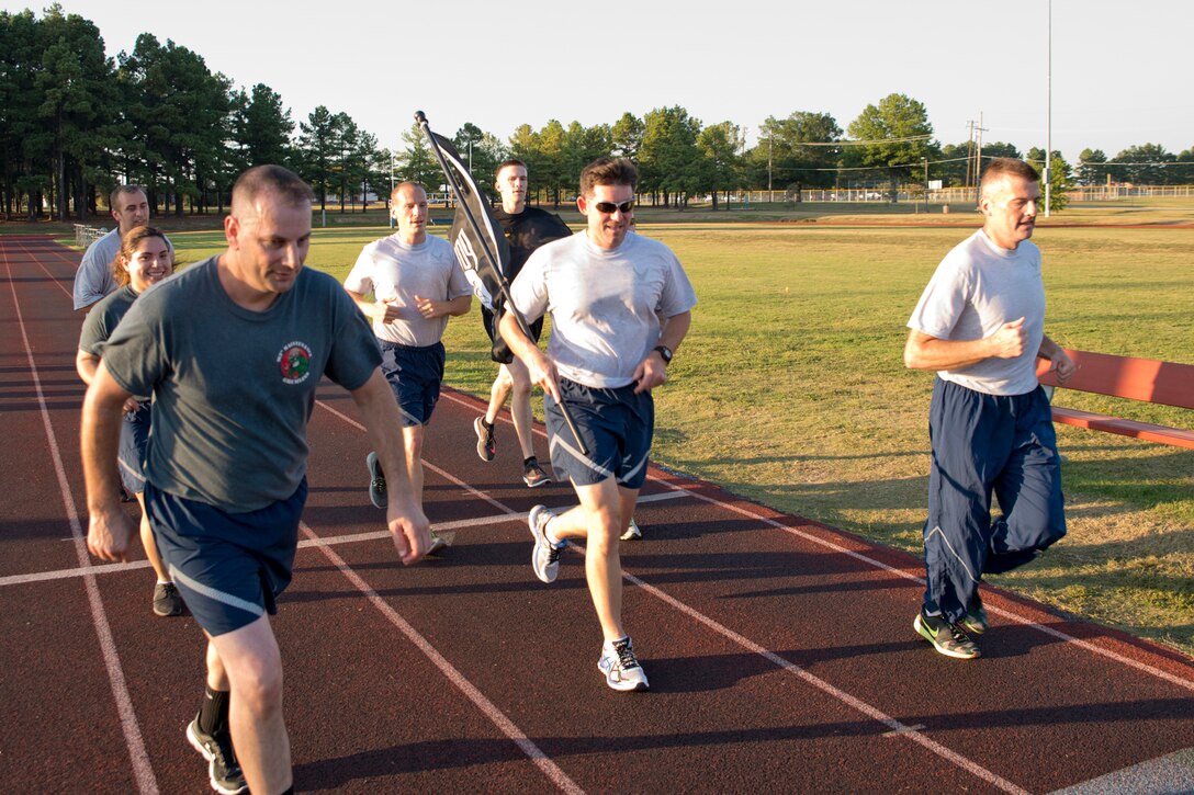 U.S. Air Force Reserve Col. Christopher Lay, (center) commander of the 913th Airlift Group, leads members of the Group around the track during a 24-hour vigil at Little Rock Air Force Base, Ark., Sept. 14, 2017. The event was held to observe National POW and MIA Recognition Day. (U.S. Air Force photo by Capt. Casey Staheli/Released)