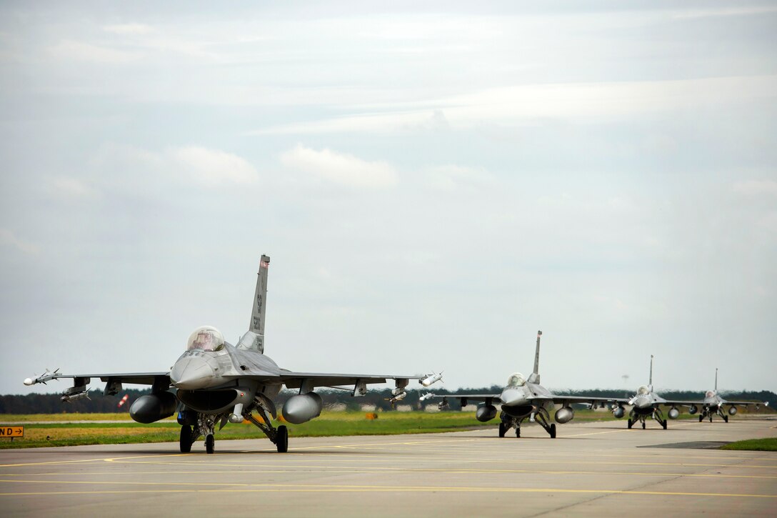 Four Air Force F-16 Falcon Falcon aircraft taxi's before taking off on a sortie.