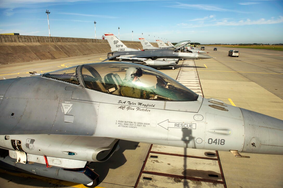 Air Force pilots conduct pre-flight checks before taking off on a sortie.