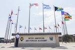 Lt. Col. Isaac Davidson, Inter-American Air Forces Academy new commandant, proudly stands in front of the circle of international flags Sept. 15 at the academy's headquarters at Joint Base San Antonio-Lackland, Texas. Davidson says he will continue to strengthen international relationships through education and training. IAAFA is preparing to celebrate 75 years of existence in March 2018 with its western hemisphere partners.