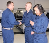 IMAGE: 170907-N-TS560-110 
GREAT LAKES, Ill. (Sept. 8, 2017) - Combat Direction Systems Activity Dam Neck Commanding Officer Cmdr. Andrew J. Hoffman (left) presents his command coin to Seaman Recruit Kurtis Bacha of Ringgold, Ga., after presenting one to Seaman Recruit Jessica Barrera of Riverside, Calif.  Hoffman was among five CDSA personnel who traveled to Recruit Training Command Great Lakes after sponsoring Division 287 during their initial Navy training.