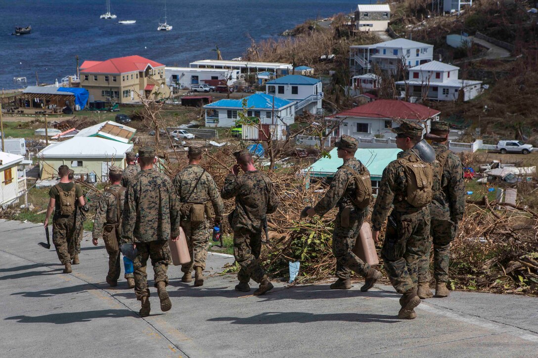 U.S. Marines Battalion Landing Team 2nd Battalion, 6th Marine Regiment, 26th Marine Expeditionary Unit (MEU), walk back to a landing zone after clearing roadways in a community affected by Hurricane Irma in St. John, U.S. Virgin Islands, Sept. 17, 2017. The 26th MEU is supporting authorities in the U.S. Virgin Islands with the combined goal of protecting the lives and safety of those in affected areas. (U.S. Marine Corps photo by Lance Cpl. Santino D. Martinez)