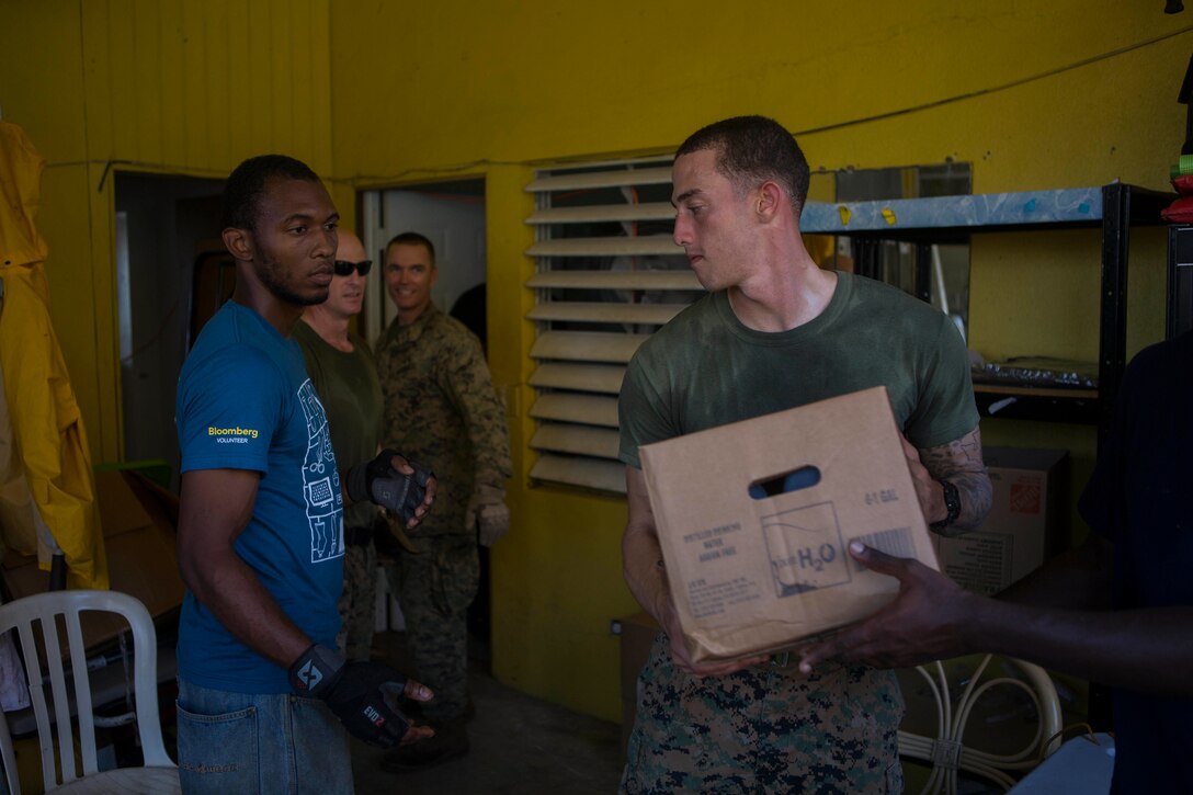 U.S. Marine Corps Sgt. Austin C. Morgan, an assaultman with Battalion Landing Team 2nd Battalion, 6th Marine Regiment, 26th Marine Expeditionary Unit (MEU), to clear debris at a local fire station that was affected by Hurricane Irma in St. John, U.S. Virgin Islands, Sept. 17, 2017.