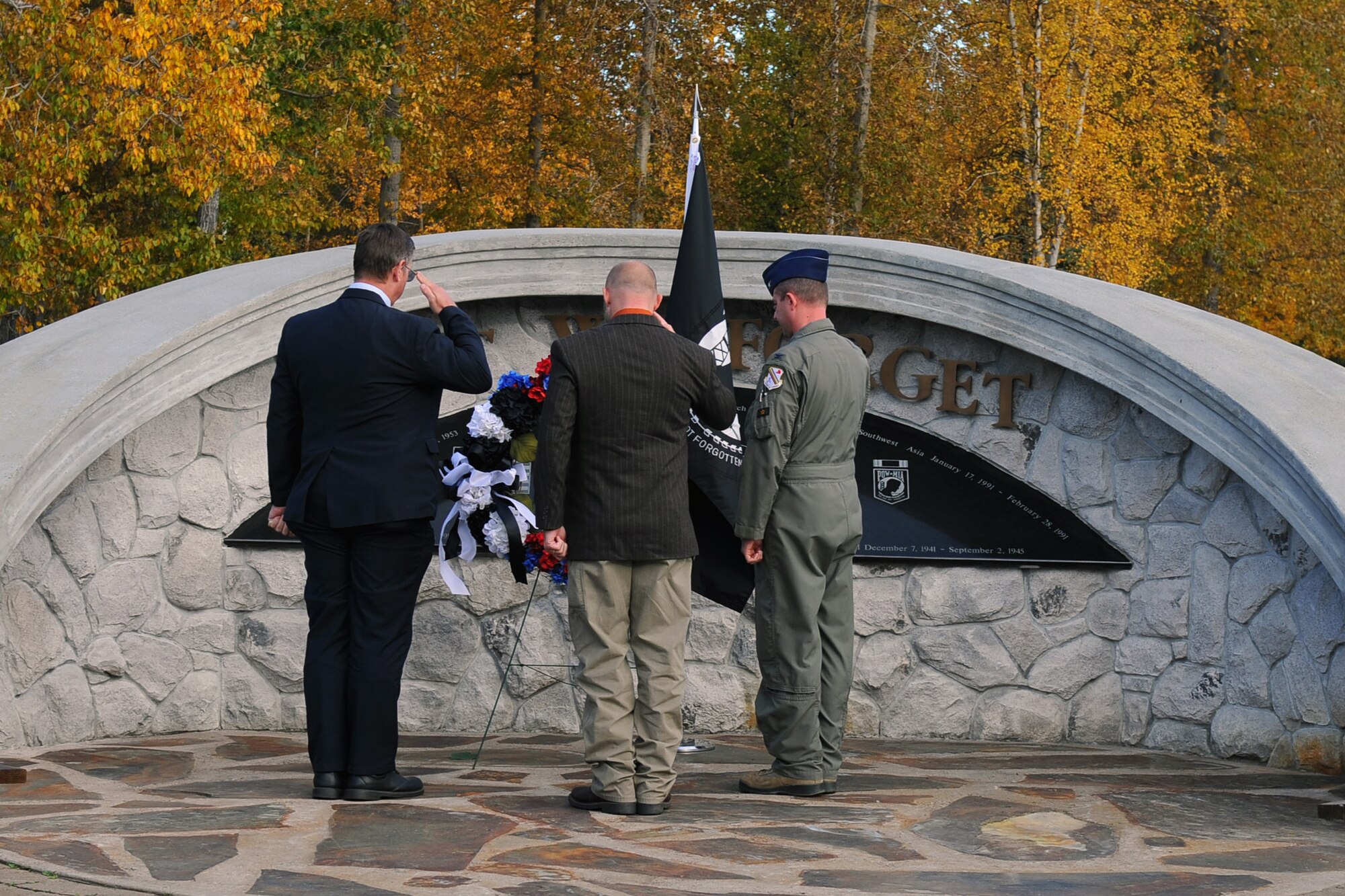 Walter Crary, left, Bryan Hinton and U.S. Air Force Col. Todd Robbins, right, 354th Fighter Wing vice commander, salute a wreath during a POW/MIA ceremony Sept. 15, 2017, at Eielson Air Force Base, Alaska. The wreath symbolizes remembrance of all prisoners of war and missing in action military member’s sacrifice. (U.S. Air Force photo by Airman 1st Class Eric M. Fisher)