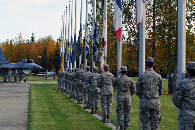 U.S. Air Force Airmen from the 354th Fighter Wing lower state flags during a POW/MIA Ceremony Sept. 15, 2017 at Eielson Air Force Base, Alaska. POW/MIA Recognition day is typically recognized on the third Friday of September every year. (U.S. Air Force photo by Airman 1st Class Eric M. Fishe