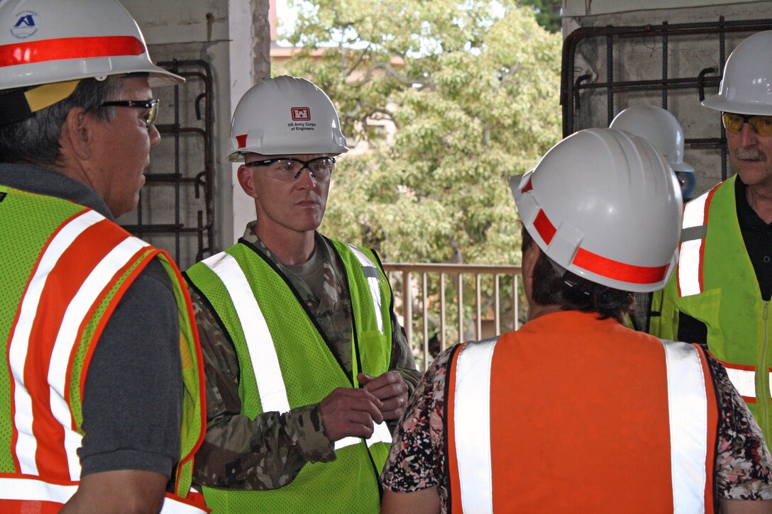 USACE Command Sergeant Major Bradley Houston talks with project engineers Sept. 13 during a tour of the Quad D project site at Schofield Barracks.