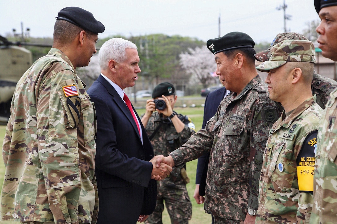 The U.S. vice president shakes hands with a South Korean general.