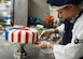 Airman 1st Class Kendall McGovern, 99th Force Support Squadron chef, prepares a layer of fondant on the Air Force's 70th anniversary celebration cake at Nellis Air Force Base, Nevada, September 17, 2017. McGovern spent more than two hours creating fondant stars and stripes to place around the multiple layers of cake. (U.S. Air Force photo by Master Sgt. Heidi West/Released)