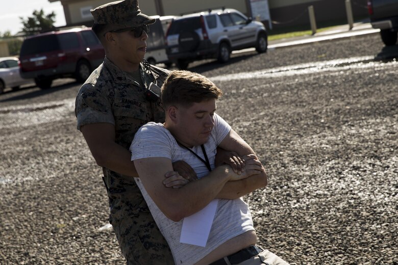 U.S. Marine Sgt.Joshua Ramirez, police officer, Provost Marshal Office, Headquarters Battalion, Marine Corps Base Hawaii (MCBH), drags a simulated victim during the Anti-Terrorism/Force Protection Exercise Lethal Breeze, aboard MCBH, Sept. 12, 2017. The exercise combined multiple agencies, on and off the installation, to respond to a simulated attack, mass casualty scenario, and an environmental oil spill. Exercise Lethal Breeze provided hands-on experience and training to prepare MCBH to protect personnel, facilities, and other assets from all threats and hazards. (U.S. Marine Corps Photo by Sgt. Alex Kouns)