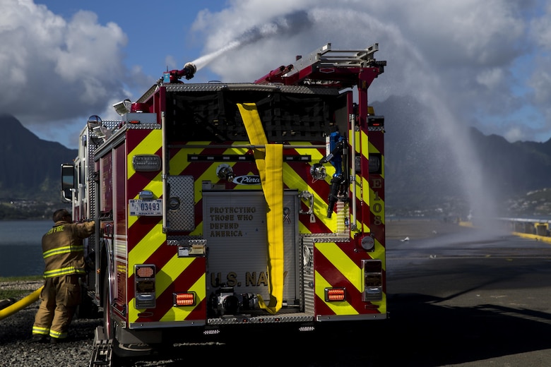 A fire fighter with the Marine Corps Base Hawaii (MCBH) Fire Department operates a fire engine during the Anti-Terrorism/Force Protection Exercise Lethal Breeze, aboard MCBH, Sept. 12, 2017. The exercise combined multiple agencies, on and off the installation, to respond to a simulated attack, mass casualty scenario, and an environmental oil spill. Exercise Lethal Breeze provided hands-on experience and training to prepare MCBH to protect personnel, facilities, and other assets from all threats and hazards. (U.S. Marine Corps Photo by Sgt. Alex Kouns)