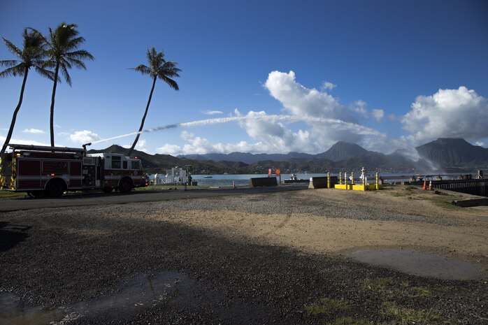 Personnel with the Marine Corps Base Hawaii (MCBH) Fire Department douse mock flames during the Anti-Terrorism/Force Protection Exercise Lethal Breeze, aboard MCBH, Sept. 12, 2017. The exercise combined multiple agencies, on and off the installation, to respond to a simulated attack, mass casualty scenario, and an environmental oil spill. Exercise Lethal Breeze provided hands-on experience and training to prepare MCBH to protect personnel, facilities, and other assets from all threats and hazards. (U.S. Marine Corps Photo by Sgt. Alex Kouns)
