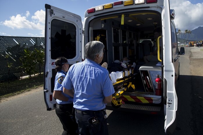 First responders with American Medical Response secure simulated victims in an ambulance during the Anti-Terrorism/Force Protection Exercise Lethal Breeze, aboard Marine Corps Base Hawaii (MCBH), Sept.12, 2017.  The exercise combined multiple agencies, on and off the installation, to respond to a simulated attack, mass casualty scenario, and an environmental oil spill. Exercise Lethal Breeze provided hands-on experience and training to prepare MCBH to protect personnel, facilities, and other assets from all threats and hazards. (U.S. Marine Corps Photo by Sgt. Alex Kouns)