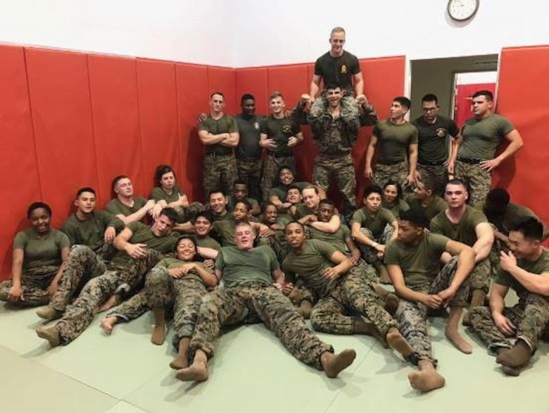 Marines pose for a group photo after a grueling Marine Martial Arts Program class led by Cpl. Jody Scott