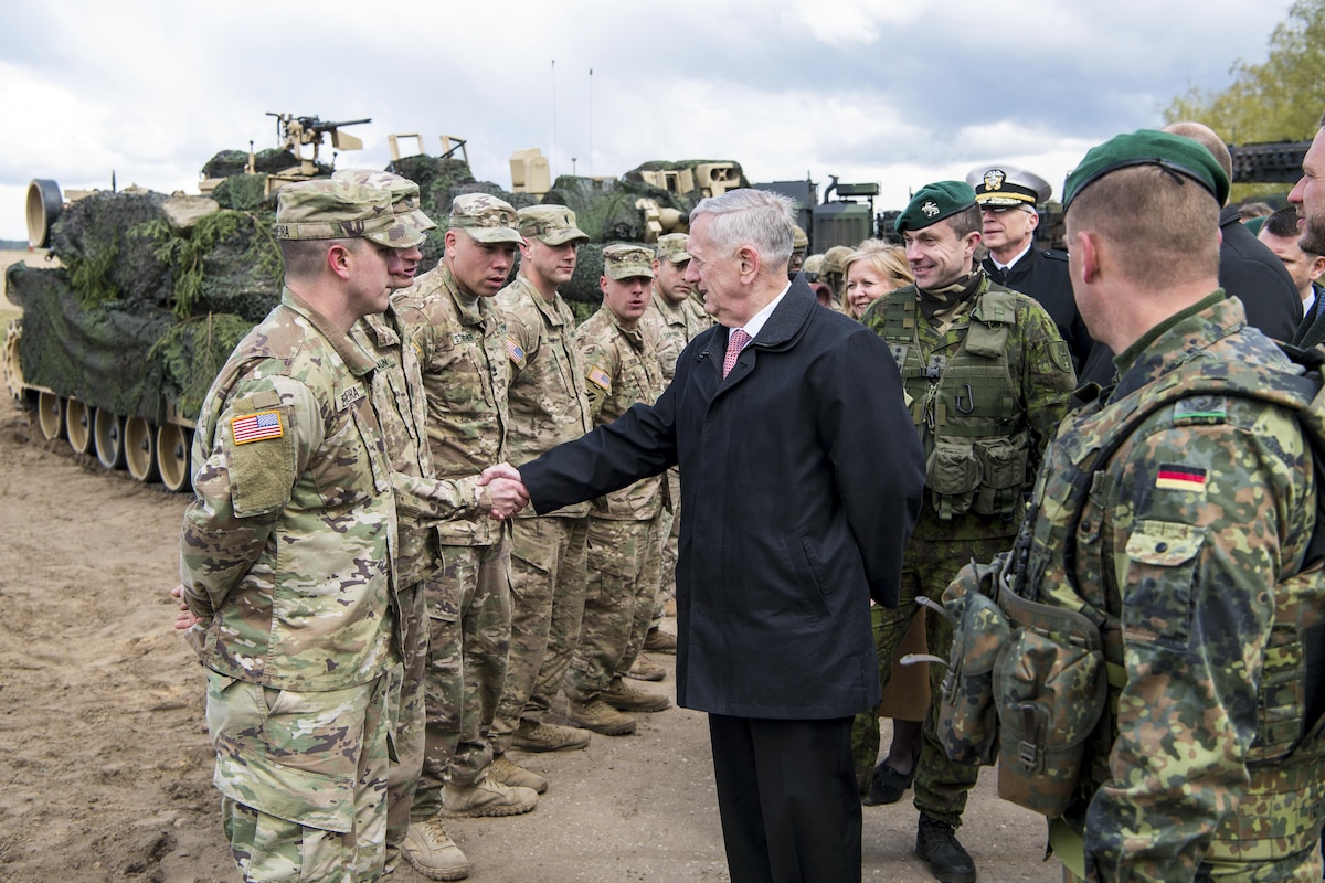 Defense Secretary James N. Mattis shakes hands with a soldier in a line of soldiers.