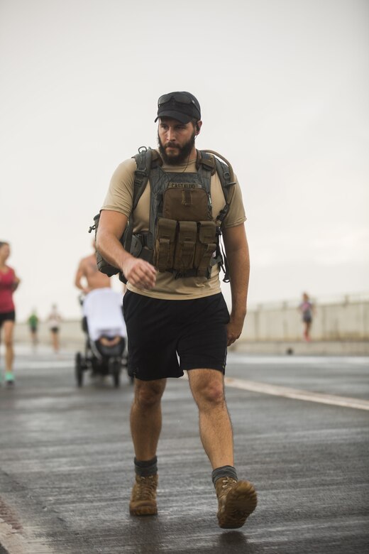 A run participant participates in the Fisher House Hero and Remembrance Run, Walk or Roll 8k on Ford Island aboard Joint Base Pearl Harbor-Hickam, Sept. 9, 2017. The road was adorned with over 7,500 military boots decorated with American flags, name tags with a photo of the service member, and information on the combat tour they were serving or where they were stationed. The free event was open to the public and military to honor those we have lost in the service since Sept. 11, 2001. (U.S. Marine Corps photo by Sgt. Zachary Orr)