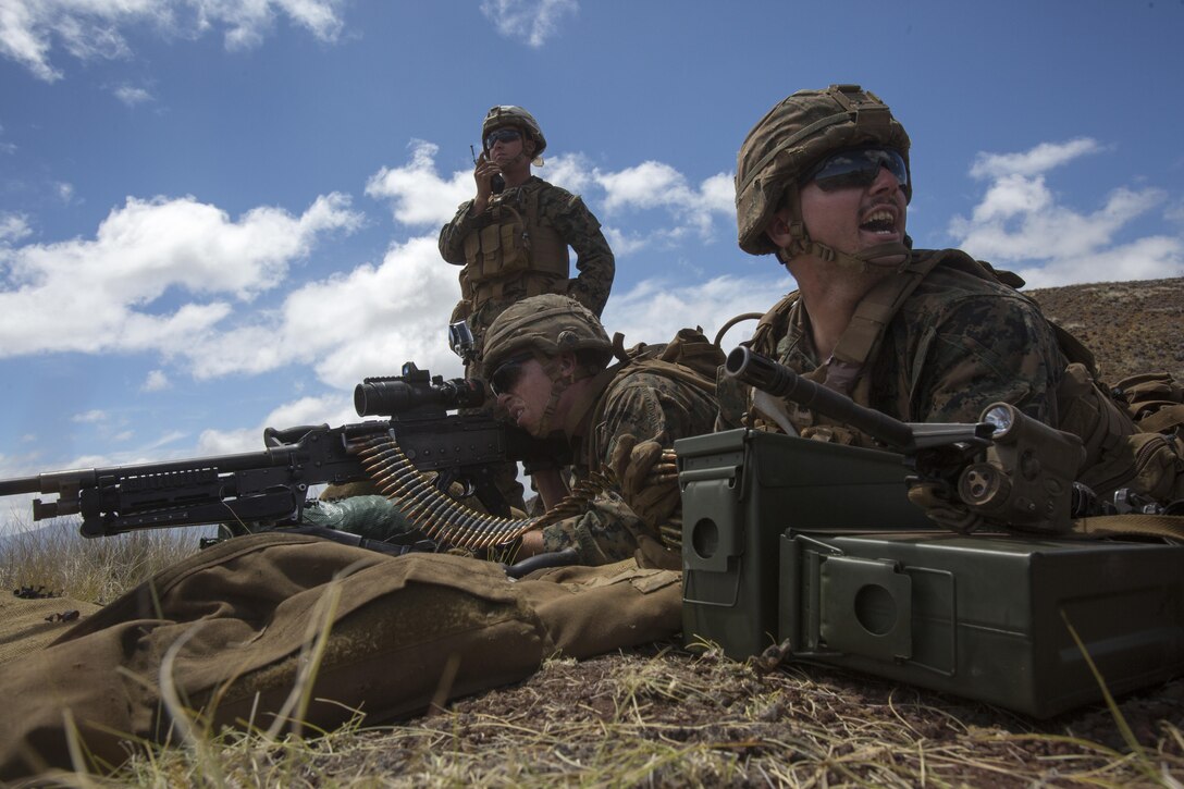POHAKULOA TRAINING AREA, HAWAII -- Lance Cpl. Shane Daly, a machine gunner with India Company, 3rd Battalion, 3rd Marine Regiment provides suppression while Cpl. Jacob Oliver, a team leader with India Co., communicates with another machine gun team during a platoon live-fire event at Pohakuloa Training Area August 23, 2017. The training event, a part of Exercise Bougainville II, consisted of a platoon-size force being transported by AAV’s to a staging area, then assaulting an enemy position with support from Daly and Oliver’s machine gun emplacement as well as 60 mm mortars. Exercise Bougainville II prepares 3rd Battalion, 3rd Marine Regiment for service as a forward deployed force in the Pacific by training them to fight as a ground combat element in a Marine Air-Ground Task Force. (U.S. Marine Corps photo by Lance Cpl. Luke Kuennen)