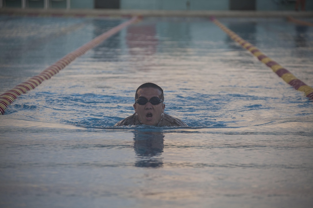 Pfc. Kelton Castagnetti, an infantryman with 4th Force Reconnaissance Company, swims across the base pool during the reconnaissance screener aboard Marine Corps Base Hawaii (MCBH) on Sept. 8, 2017. Screeners with 3rd Reconnaissance Battalion evaluated service members interested in attending the Basic Reconnaissance Course with a physical fitness test, aquatic exercises at the base pool, followed by the maneuver under fire portion of the combat fitness test twice, ending with a 6-mile-long pack run. (U.S. Marine Corps photo by Cpl. Jesus Sepulveda Torres)
