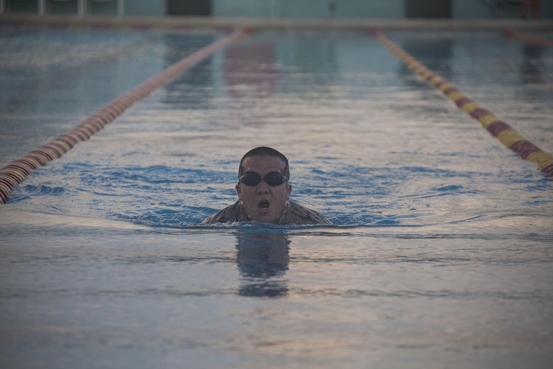 Pfc. Kelton Castagnetti, an infantryman with 4th Force Reconnaissance Company, swims across the base pool during the reconnaissance screener aboard Marine Corps Base Hawaii (MCBH) on Sept. 8, 2017. Screeners with 3rd Reconnaissance Battalion evaluated service members interested in attending the Basic Reconnaissance Course with a physical fitness test, aquatic exercises at the base pool, followed by the maneuver under fire portion of the combat fitness test twice, ending with a 6-mile-long pack run. (U.S. Marine Corps photo by Cpl. Jesus Sepulveda Torres)