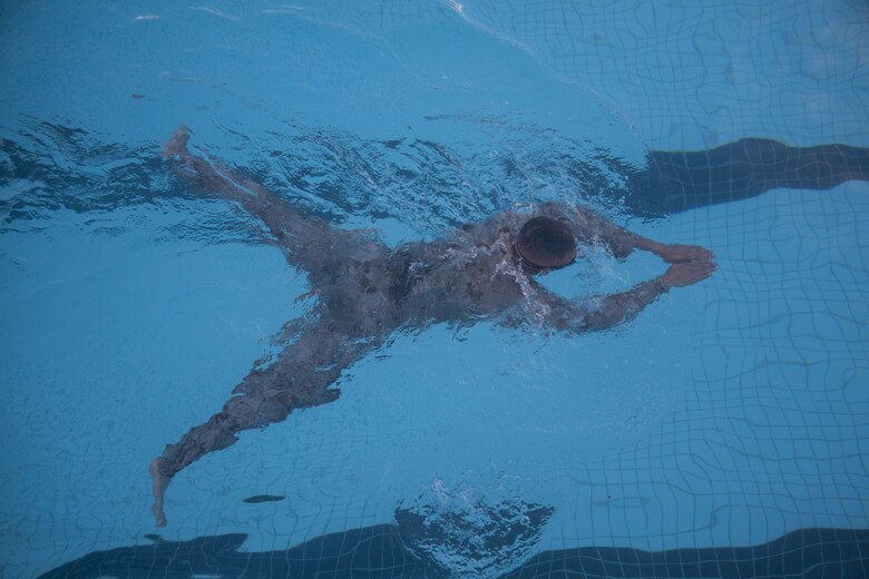 Pfc. Michael Graziano, an infantryman with 4th Force Reconnaissance Company, swims across the base pool during the reconnaissance screener aboard Marine Corps Base Hawaii (MCBH)  on Sept. 8, 2017. Screeners with 3rd Reconnaissance Battalion evaluated service members interested in attending the Basic Reconnaissance Course with a physical fitness test, aquatic exercises at the base pool, followed by the maneuver under fire portion of the combat fitness test twice, ending with a 6-mile-long pack run. (U.S. Marine Corps photo by Cpl. Jesus Sepulveda Torres)