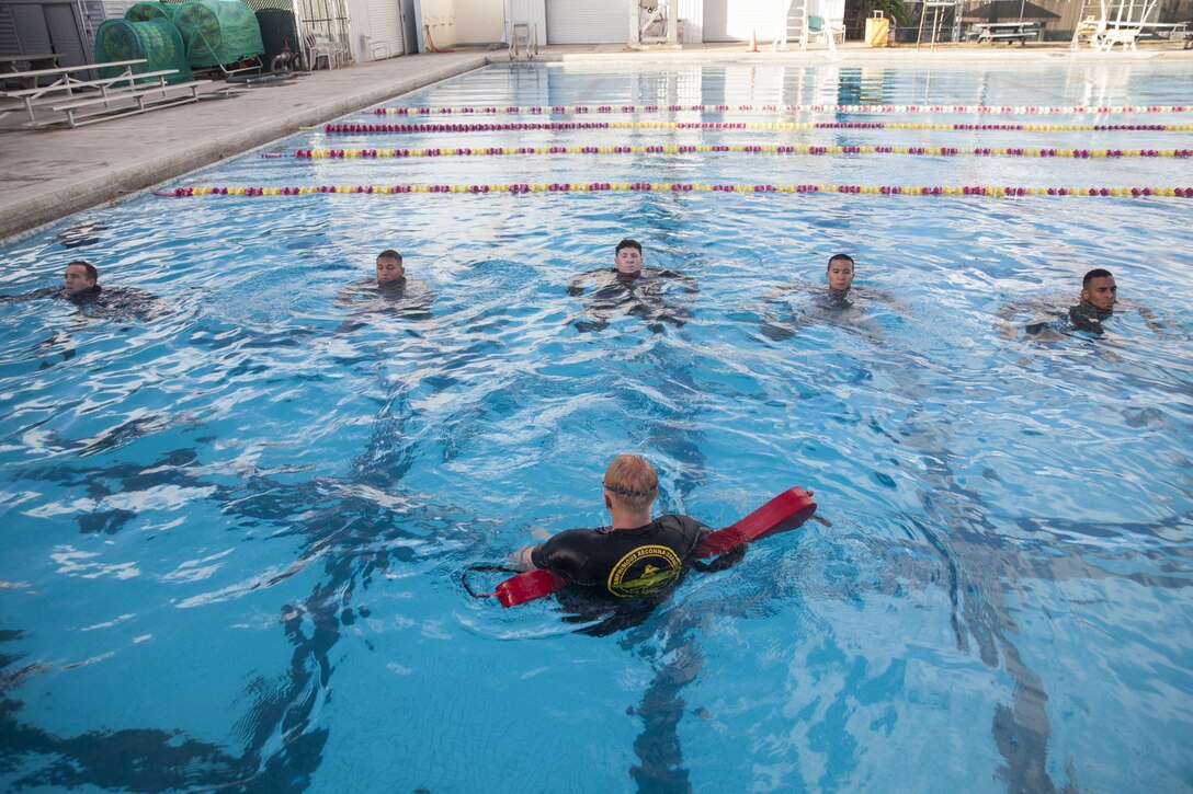 U.S. Marines with Marine Corps Base Hawaii (MCBH) tread water at the base pool during the reconnaissance screener aboard MCBH on Sept. 8, 2017. Screeners with 3rd Reconnaissance Battalion evaluated service members interested in attending the Basic Reconnaissance Course with a physical fitness test, aquatic exercises at the base pool, followed by the maneuver under fire portion of the combat fitness test twice, ending with a 6-mile-long pack run. (U.S. Marine Corps photo by Cpl. Jesus Sepulveda Torres)