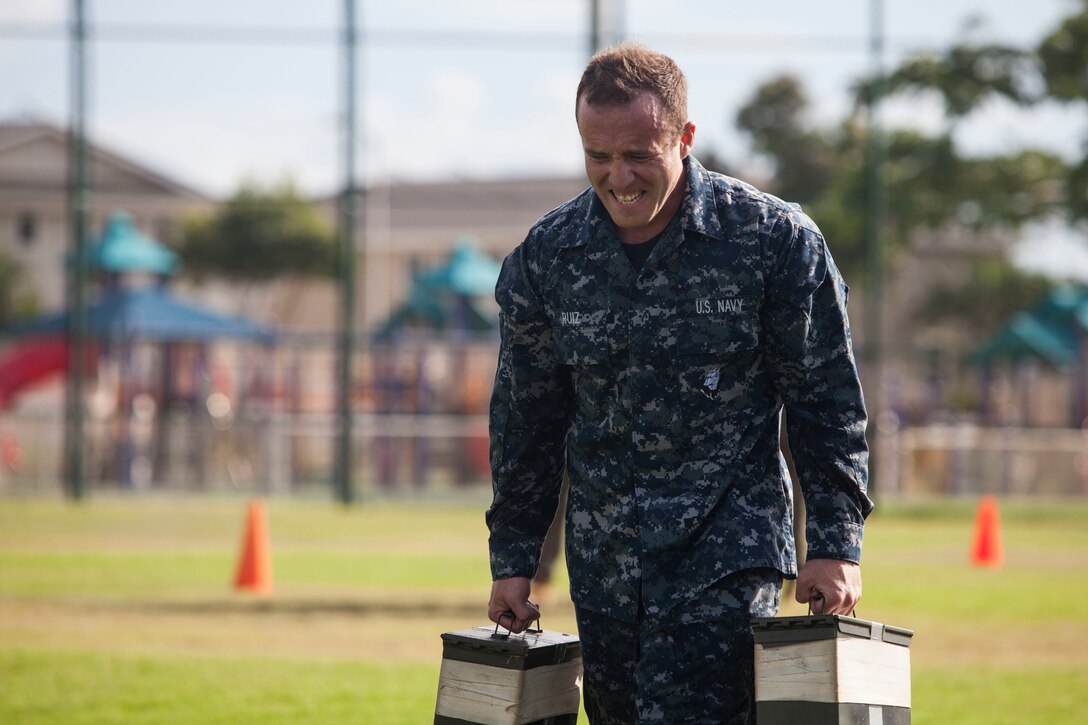 Seaman Anthony Ruiz, a craft master with Arizona Detachment, Joint Base Pearl Harbor-Hickam, carries ammo cans during the maneuver under fire portion of the combat fitness test (CFT) part of the reconnaissance screener aboard Marine Corps Base Hawaii (MCBH) on Sept. 8, 2017. Screeners with 3rd Reconnaissance Battalion evaluated service members interested in attending the Basic Reconnaissance Course with a physical fitness test, aquatic exercises at the base pool, followed by the maneuver under fire portion of the CFT twice, ending with a 6-mile-long pack run. (U.S. Marine Corps photo by Cpl. Jesus Sepulveda Torres)