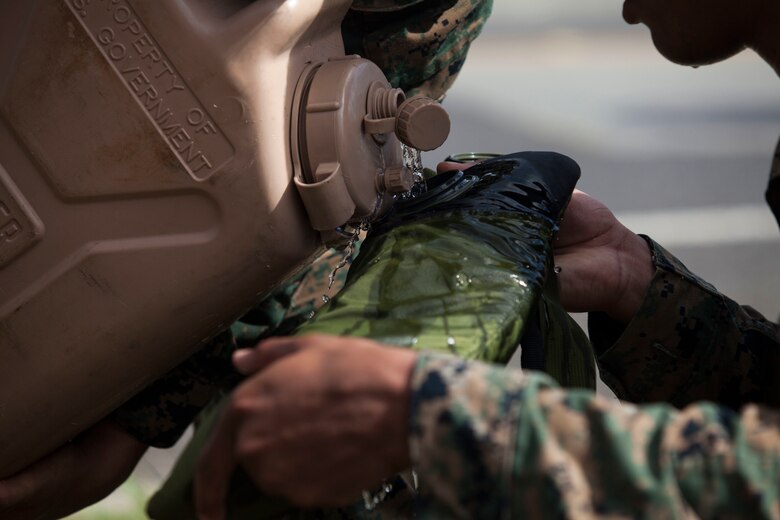 U.S. Marines with Marine Corps Base Hawaii (MCBH) refill their camelbacks prior to conducting a hike part of the reconnaissance screener aboard MCBH on Sept. 8, 2017. Screeners with 3rd Reconnaissance Battalion evaluated service members interested in attending the Basic Reconnaissance Course with a physical fitness test, aquatic exercises at the base pool, followed by the maneuver under fire portion of the combat fitness test twice, ending with a 6-mile-long pack run. (U.S. Marine Corps photo by Cpl. Jesus Sepulveda Torres)