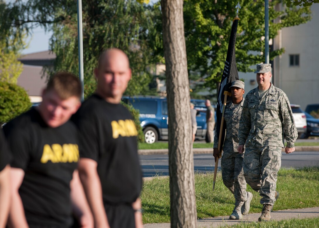 U.S. Air Force Col. David G. Shoemaker, 8th Fighter Wing commander, and Chief Master Sgt. Reiko L. Meeks, 8th FW command chief, carry the Prisoner of War and Missing in Action flag to the running track during the opening ceremony of POW/MIA Recognition Day at Kunsan Air Base, Republic of Korea, Sept. 14, 2017. Shoemaker and Meeks ran the first leg of the 24-hour run in remembrance of the POW/MIA service members. (U.S. Air Force photo by Staff Sgt. Victoria H. Taylor)